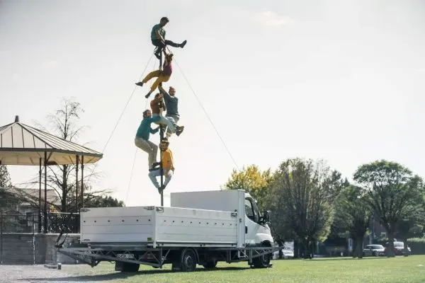 Circusartiesten klimmen op een paal
